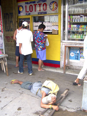 Beggar in front of lotto station
