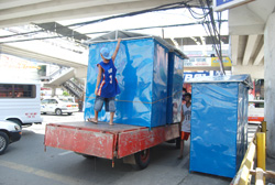 Workers put up portable comfort rooms at the food festival area along Valeria-Delgado streets in preparation for the Dinagyang highlights this weekend.