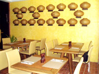 The dining area with structural art on the wall.