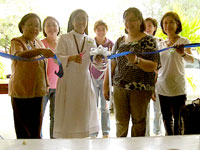 Sr Rebecca cuts the ribbon to open the bazaar.