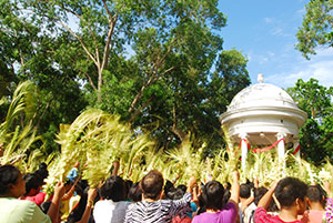 Devotees wave their palms in front of St. Anne Parish Church  in Molo District during Palm Sunday.