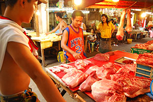 A man tries to buy pork from a dealer inside the Iloilo Central Market. Health officials reiterated that eating pork is safe amid fears of the spread of H1N1 virus.